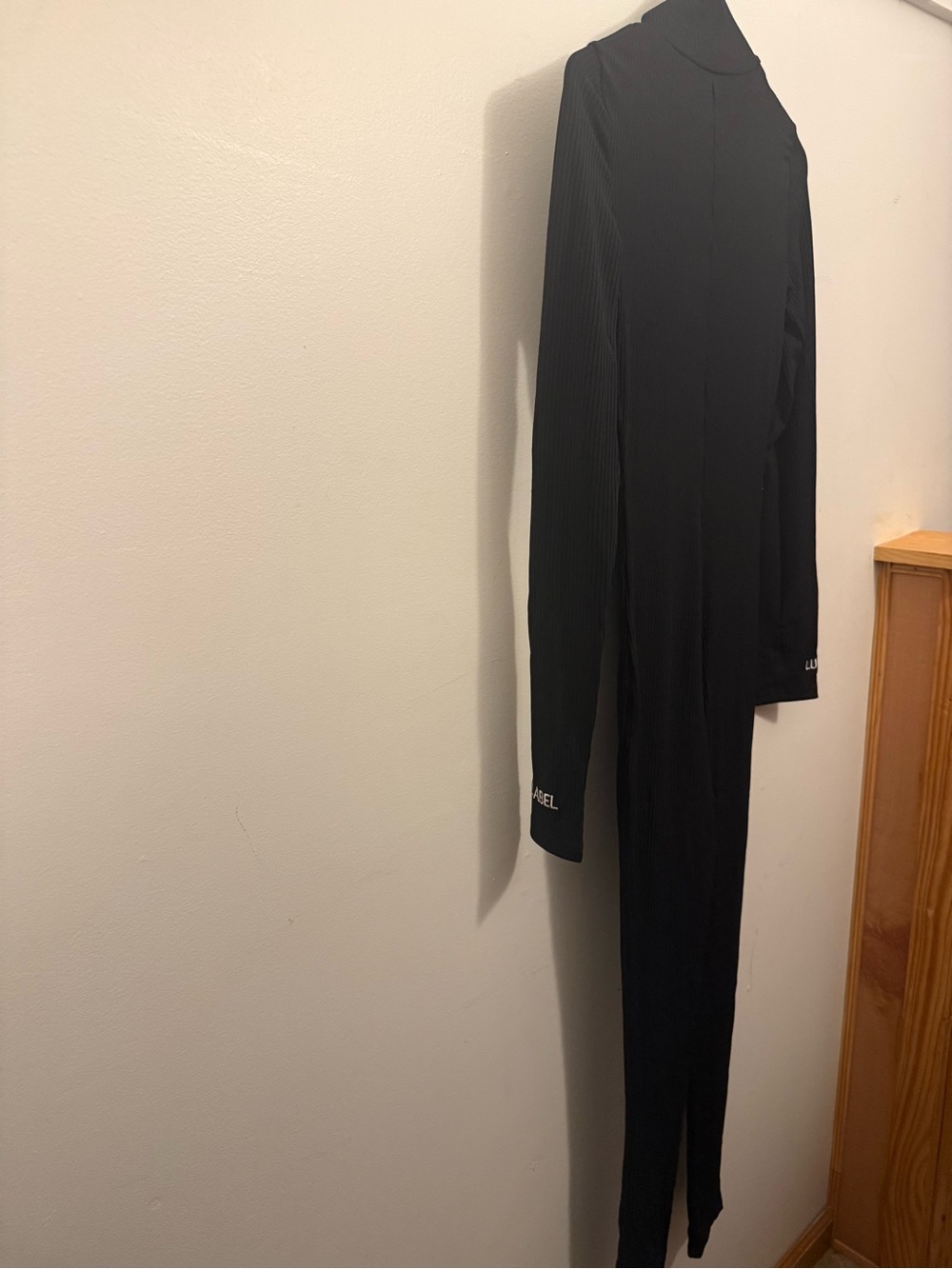 Black Long-Sleeve Turtleneck Jumpsuit with Subtle Cuff Logo